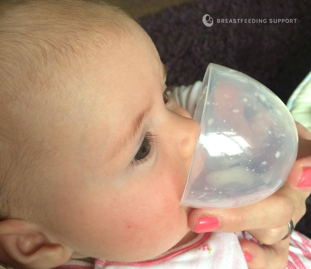 baby drinking from an open cup